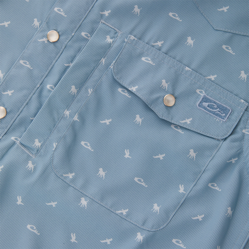 Cinco Ranch Western Short Sleeve Shirt with light-blue pin-striped fabric, white fish-like print, snap flap pocket, and brand patch above, ideal for versatile outdoor activities.