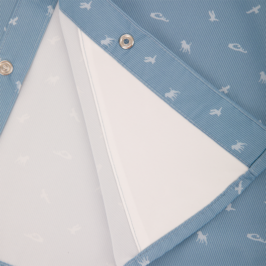 Close-up of Cinco Ranch Western Short Sleeve Shirt's pin-striped fabric with white animal silhouettes, showing waterproof inner layer and metal snap-fasteners.