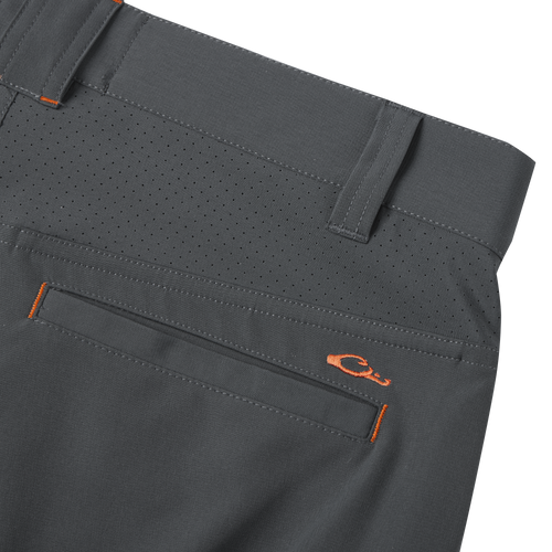 Close-up of Lake Shore Performance Short, showcasing technical features like a zippered cargo pocket and laser-punched details for breathability, ideal for fishing and outdoor activities.
