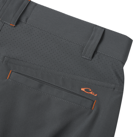 Close-up of Lake Shore Performance Short, showcasing technical features like a zippered cargo pocket and laser-punched details for breathability, ideal for fishing and outdoor activities.