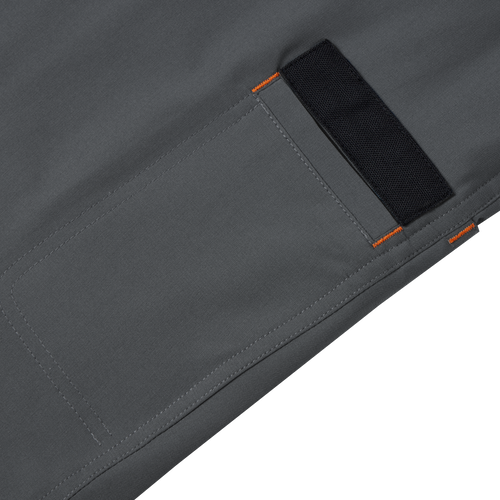 Close-up of Lake Shore Performance Short, featuring a zippered left cargo pocket and black fabric label on grey fabric, highlighting technical design for versatile outdoor activities.