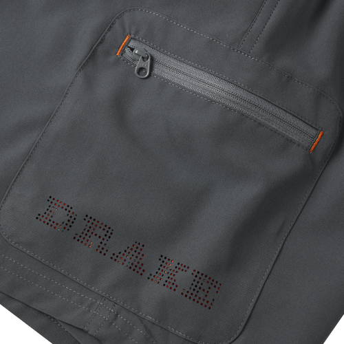 Close-up of the Lake Shore Performance Short, highlighting a zippered cargo pocket and detailed stitching, showcasing its technical design and functionality for outdoor activities.