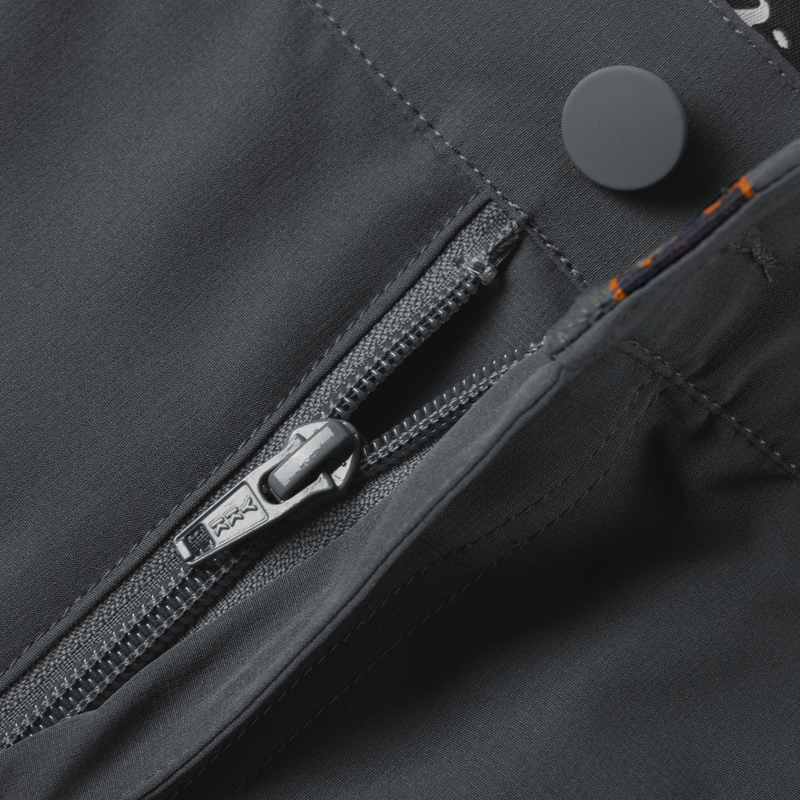 Lake Shore Performance Short showcasing a close-up of the zippered left cargo pocket, emphasizing the technical design and functionality for versatile outdoor activities.