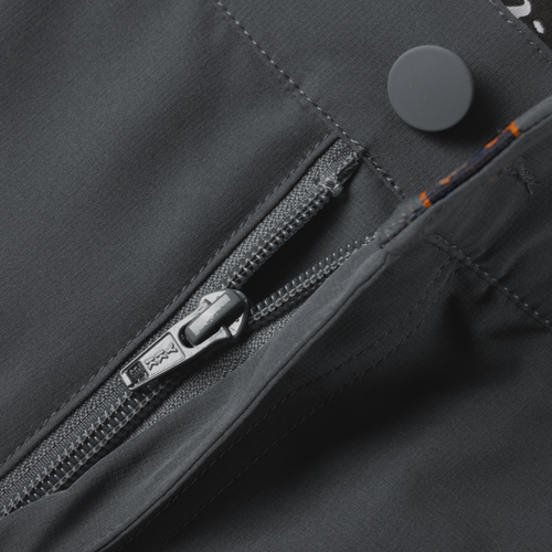Lake Shore Performance Short showcasing a close-up of the zippered left cargo pocket, emphasizing the technical design and functionality for versatile outdoor activities.