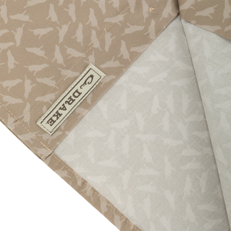 Close-up of Cotton Lab Print Short Sleeve Shirt, showcasing the soft cotton blend poplin fabric with a label detail, highlighting its lightweight and versatile design.