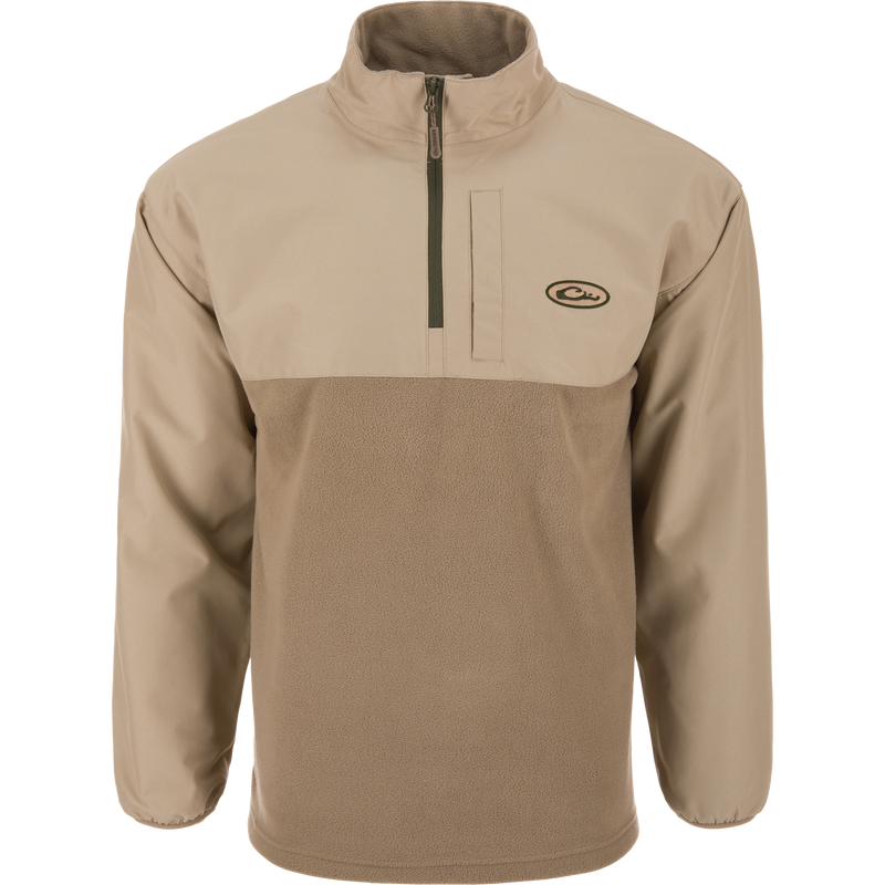 Eqwader Half Zip Pullover featuring a light tan design with a waterproof upper shell, fleece lower body, stand-up collar, and zippered chest pocket, ideal for waterfowl hunting.
