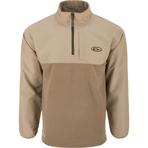 Eqwader Half Zip Pullover featuring a light tan design with a waterproof upper shell, fleece lower body, stand-up collar, and zippered chest pocket, ideal for waterfowl hunting.