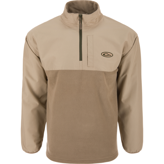 Eqwader Half Zip Pullover featuring a light tan design with a waterproof upper shell, fleece lower body, stand-up collar, and zippered chest pocket, ideal for waterfowl hunting.