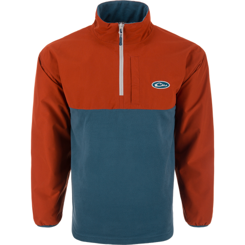 Eqwader Half Zip Pullover with rust-orange waterproof upper and teal breathable lower, featuring a short zip, elastic cuffs, and chest logo. Ideal for waterfowl hunting.