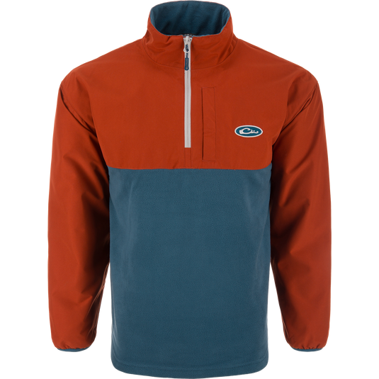 Eqwader Half Zip Pullover with rust-orange waterproof upper and teal breathable lower, featuring a short zip, elastic cuffs, and chest logo. Ideal for waterfowl hunting.