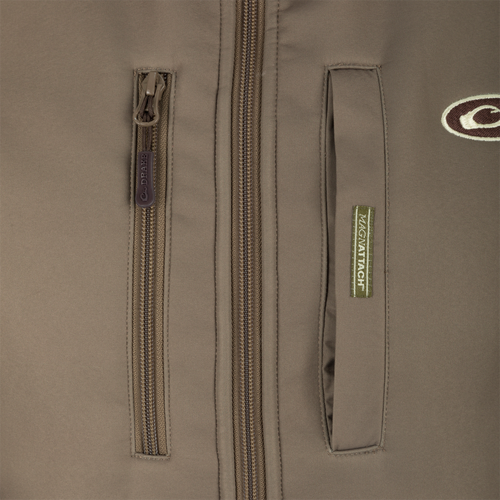 Close-up of the Hole Shot Solid Vest's YKK zipper and high handwarmer pockets, showcasing windproof and breathable materials ideal for cold weather.