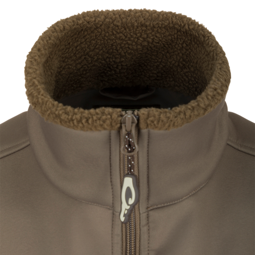Close-up of the Hole Shot Solid Vest, highlighting the zipper, high handwarmer pockets, and adjustable waist for windproof and warm functionality.