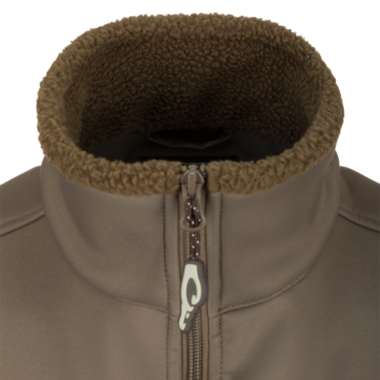 Close-up of the Hole Shot Solid Vest, highlighting the zipper, high handwarmer pockets, and adjustable waist for windproof and warm functionality.