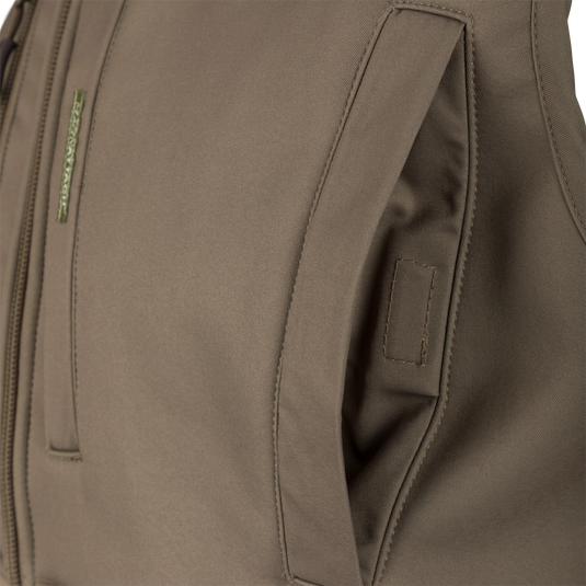 Close-up of the Hole Shot Solid Vest, highlighting high handwarmer pockets and durable fabric, designed for wind protection and warmth.