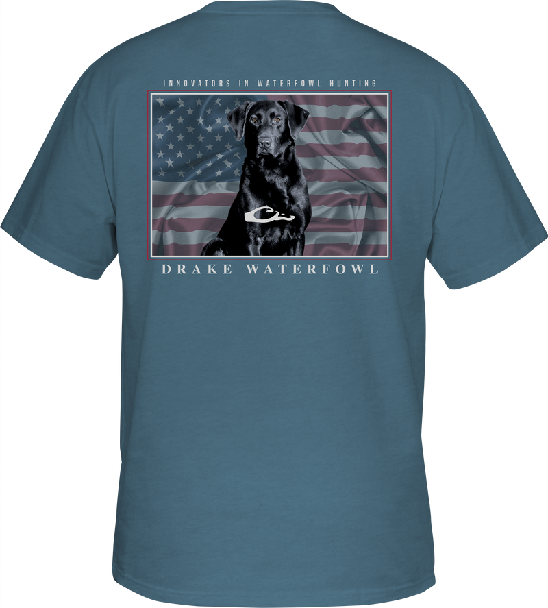 A blue shirt with a dog and an American flag overprint, featuring the Drake logo pocket on the front - Americana Lab T-Shirt.
