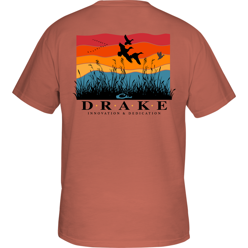 Flyway Sunrise Cotton T-Shirt featuring a graphic of birds flying over grass, part of Drake's Heritage Cotton Series, known for its soft, garment-washed comfort.