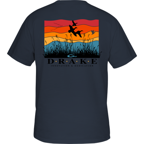 Flyway Sunrise Cotton T-Shirt displaying birds in flight over a sunset scene on the back, crafted from garment-washed 100% cotton for comfort.