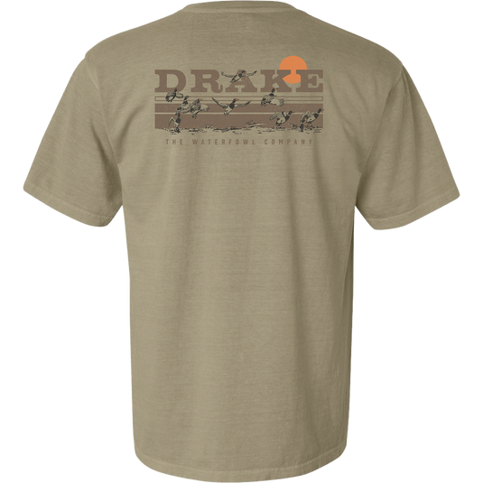 Back of the Take Flight T-Shirt featuring the Purewhitelaneshop logo, orange sun, and ducks in flight across a marsh, highlighting outdoor hunting themes.
