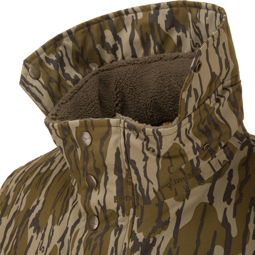 Throwback 80 Insulated Sport Bomber Jacket featuring a camouflage-patterned shell, fleece-lined interior, and metal snap buttons on the collar for warmth and protection.