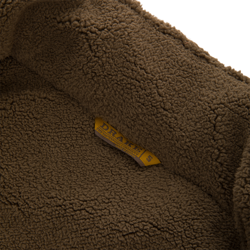 Inside view of the Throwback 80 Insulated Sport Bomber Jacket with sherpa fleece lining and a DRAKE'S label, showcasing its cozy interior design.