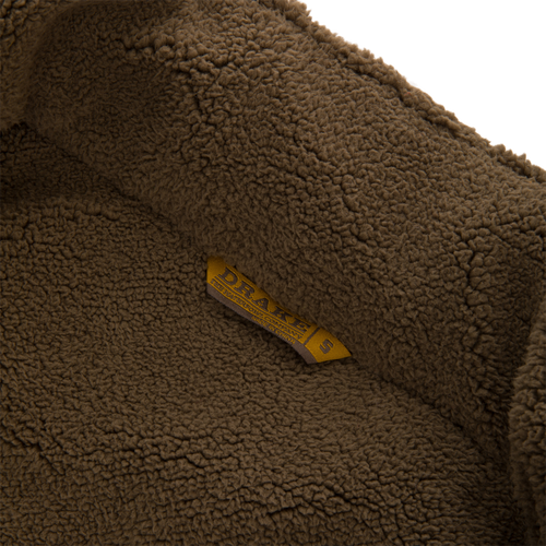 Inside view of the Throwback 80 Insulated Sport Bomber Jacket with sherpa fleece lining and a DRAKE'S label, showcasing its cozy interior design.