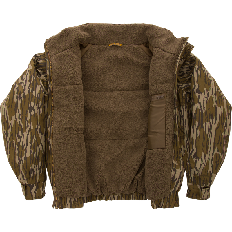 Throwback 80 Insulated Sport Bomber Jacket with camo exterior and brown sherpa fleece lining, featuring large accessory pockets, flip-up collar, and adjustable cuffs.