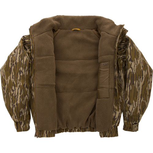 Throwback 80 Insulated Sport Bomber Jacket with camo exterior and brown sherpa fleece lining, featuring large accessory pockets, flip-up collar, and adjustable cuffs.