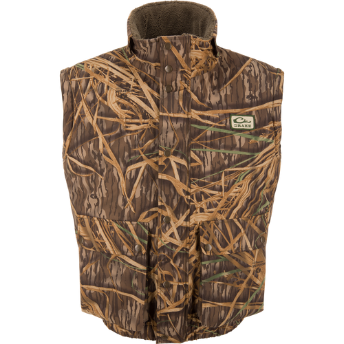 Drake's Throwback 80 Sport Vest, sleeveless camo with snap-front, features large pockets, high collar, and fleece lining for warmth, ideal for outdoor hunting adventures.
