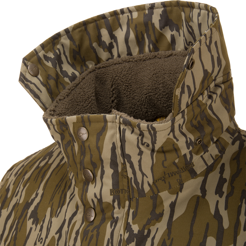Throwback 80 Sport Vest with tiger-stripe camouflage, snap-button placket, and fleece-lined collar, designed for outdoor enthusiasts with waterproof, windproof materials and accessory pockets.