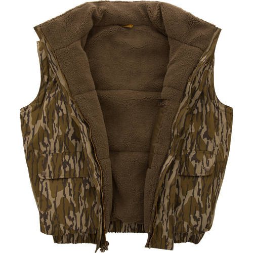 Throwback 80 Sport Vest with camouflage print, sherpa fleece lining, zip front, and snap-flap pockets, designed for outdoor adventures and maximum weather protection.