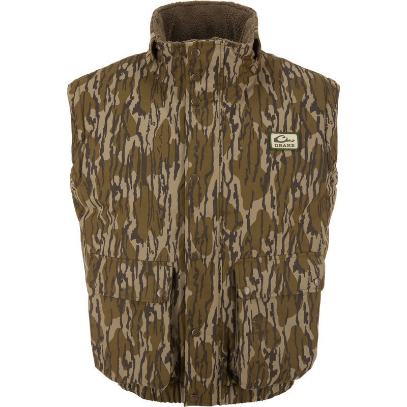 Throwback 80 Sport Vest: Sleeveless camouflage vest with high fleece collar, snap-front closures, large pockets, and Drake patch, designed for outdoor adventures.