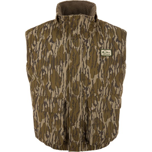 Throwback 80 Sport Vest: Sleeveless camouflage vest with high fleece collar, snap-front closures, large pockets, and Drake patch, designed for outdoor adventures.