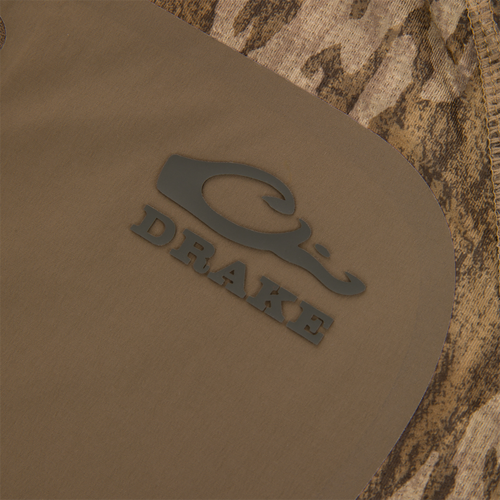 Close-up of the EST Offset 1.0 Half Zip Pullover with Drake logo, showcasing neoprene-like fabric and camouflage, designed for comfort and breathability in hunting environments.