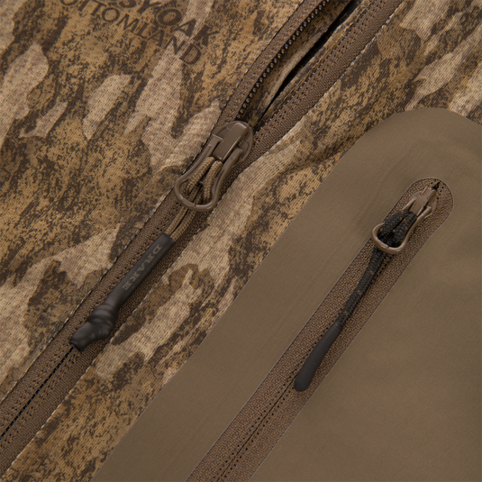 Close-up of EST Offset 1.0 Half Zip Pullover's waterproof zipper pulls on camo fabric, highlighting its water-resistant, functional design for hunting and outdoor activities.