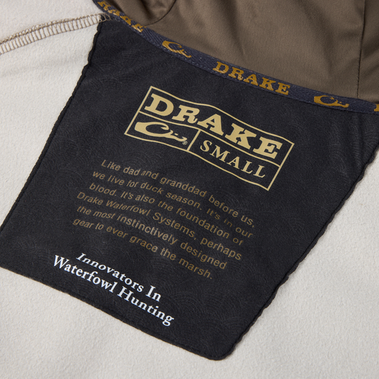 Label inside the MST Offset 2.0 Half Zip Hoodie by Purewhitelaneshop, detailing size, heritage blurb, and tagline Innovators In Waterfowl Hunting.