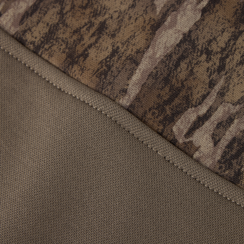 MST Offset 2.0 Half Zip Hoodie close-up showing the seam joining olive-green knit and camouflage-patterned fabric, highlighting its durable, stretchy construction.