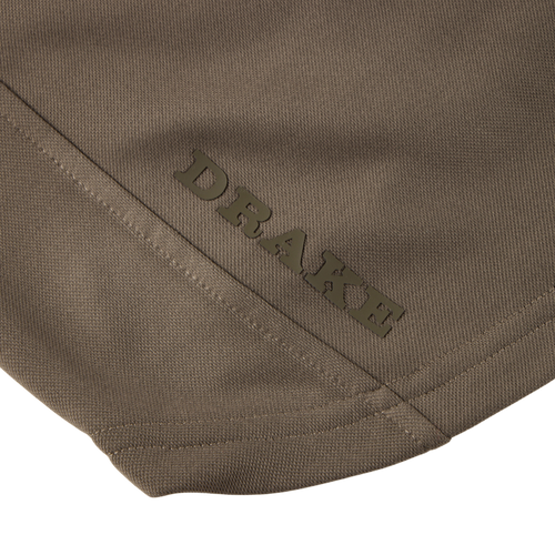 Close-up of the MST Offset 2.0 Half Zip Hoodie’s olive-drab fabric panel featuring the DRAKE brand name above a diagonal seam.