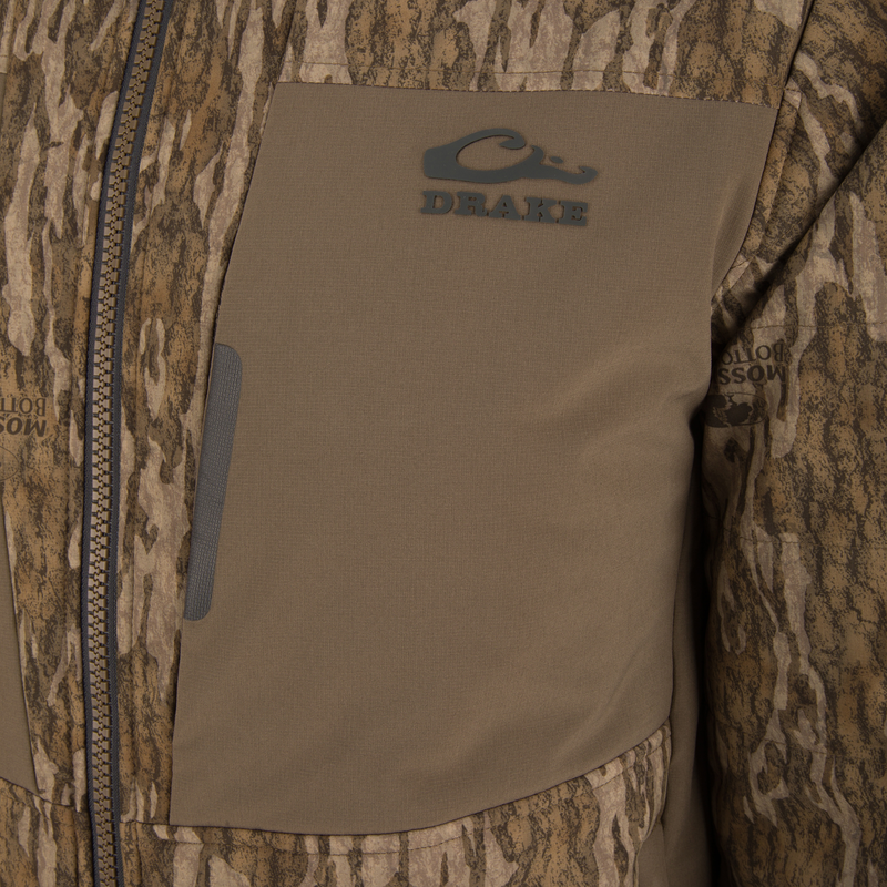 LST BMF Jacket with Primaloft features a camo pattern, Drake logo, and Mossy Oak print, showcasing a durable, water-resistant design with insulation and functional zippers.