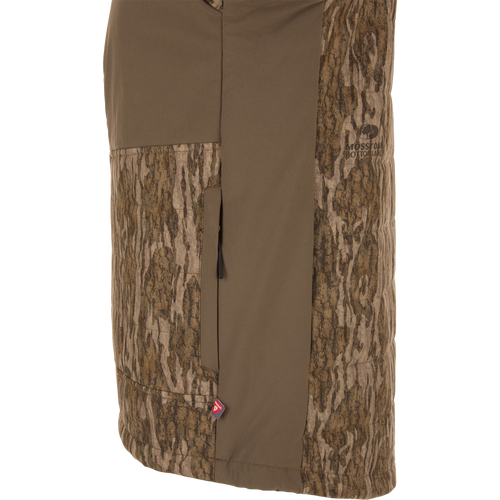 LST BMF Jacket with Primaloft in Mossy Oak Bottomland camo, featuring a vertical zippered pocket, PrimaLoft tag, and durable, water-resistant stretch fabric.