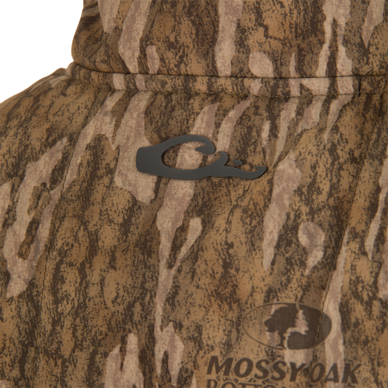 Close-up of LST BMF Vest with Primaloft, featuring Mossy Oak camouflage, rubberized emblem, and Magnattach chest pocket on windproof, breathable ripstop fabric with DWR finish.