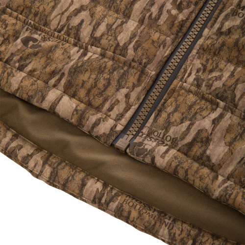 Close-up of LST BMF Vest with Primaloft, showcasing Mossy Oak Bottomland camo pattern, quilted fabric, YKK zipper, and Magnattach™ chest pocket. Ideal for versatile hunting layering.