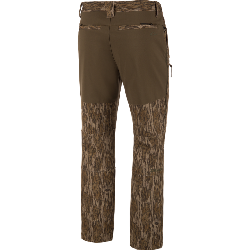 MST CommandXT Softshell Pant with bark-style camo and olive waistband, featuring belt loops, rear welt pockets, and zippered side pocket for outdoor activities.