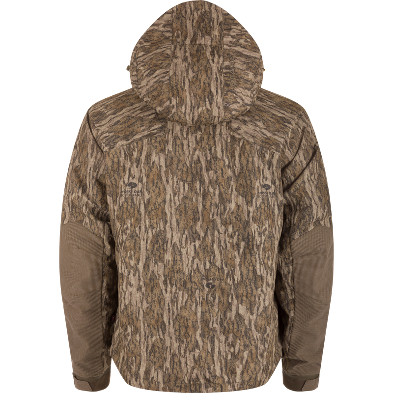 Back view of LST CommandXT 3-in-1 PrimaLoft Insulated Jacket featuring Mossy Oak Bottomland camouflage, hood, reinforced elbows, and Magnattach™ pockets, designed for versatile woodland hunting concealment.