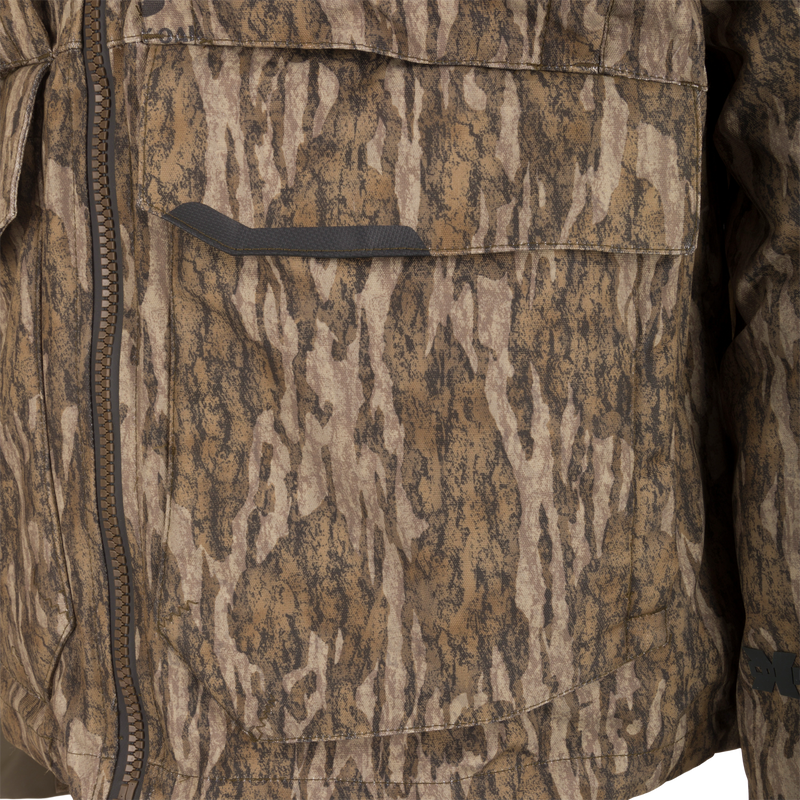 CommandXT 3-in-1 PrimaLoft Insulated Jacket with a camouflage pattern, featuring a front zipper, slanted pocket flap, and durable, weatherproof materials for versatile hunting conditions.