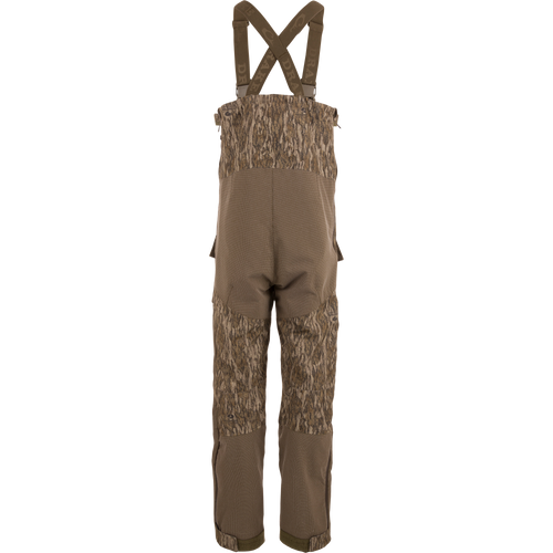 LST CommandXT Bib with Primaloft features camouflage overalls, adjustable suspenders, and reinforced panels, designed for warmth and durability in extreme hunting conditions.
