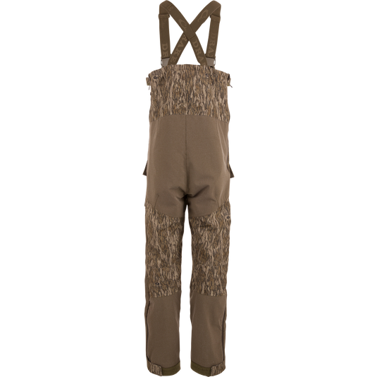 LST CommandXT Bib with Primaloft features camouflage overalls, adjustable suspenders, and reinforced panels, designed for warmth and durability in extreme hunting conditions.