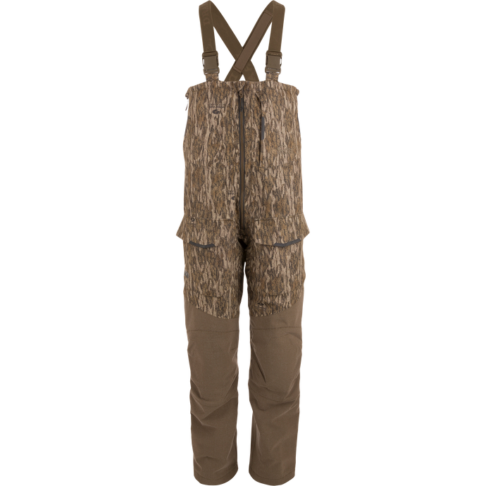 LST CommandXT Bib with Primaloft, featuring camouflage design, adjustable suspenders, multiple pockets, and front zipper; ideal for blending into woodland hunting environments.