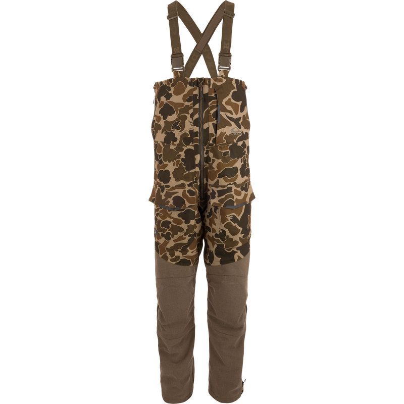 LST CommandXT Bib with Primaloft features camouflage pattern, adjustable suspenders, reinforced legs, and multiple cargo pockets, ideal for extreme outdoor conditions and hunting.