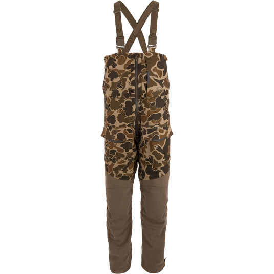 LST CommandXT Bib with Primaloft features camouflage pattern, adjustable suspenders, reinforced legs, and multiple cargo pockets, ideal for extreme outdoor conditions and hunting.