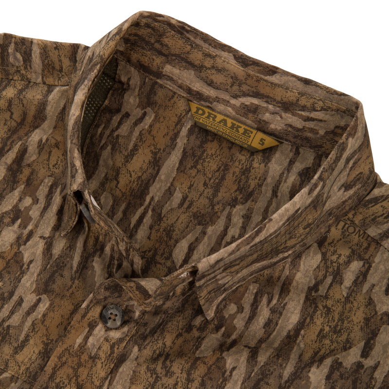 EST Wingshooter Trey Long Sleeve Shirt with vented back, multiple pockets, and hidden button-down collar, ideal for outdoor activities with UPF 30 protection and moisture-wicking features.
